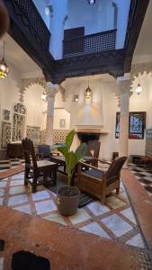 a large room with chairs and a table and a plant at Riad Arous Chamel in Tangier