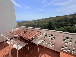 a table and chairs on a balcony with a view at Art & Motion Union - Guest Room 2 in Apoíkia