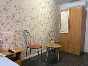 a room with two chairs and a table and a bedroom at Casa Dorina 2 in Techirghiol