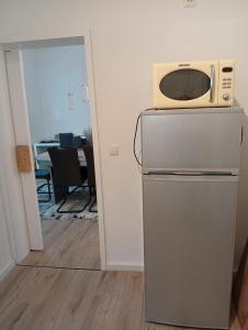 a microwave sitting on top of a refrigerator at FeWoZentrum in Lüdenscheid