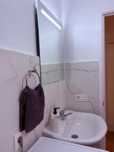 a bathroom with a sink and a mirror at Casa Lana - Cozy Beachside Studio in Puertito de Güímar +5 photos