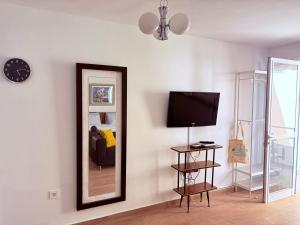 a living room with a mirror and a couch at Casa Lana - Cozy Beachside Studio in Puertito de Güímar