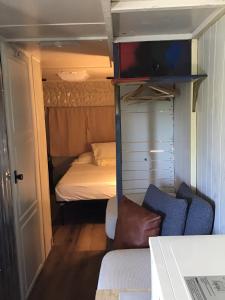 a small room with a bunk bed and a couch at Tim Vales place in Tampa