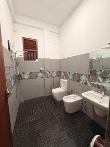 a bathroom with two sinks and two toilets in it at WILSON VILLA in Hikkaduwa +34 photos