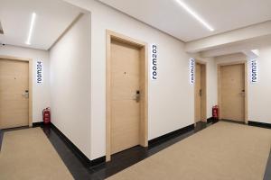 a row of doors in a room with a hallway at The Stay Pyramids Inn in Cairo +73 photos