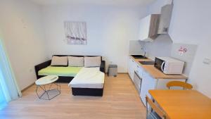 a small room with a bed and a kitchen at Apartman Anita in Jesenice