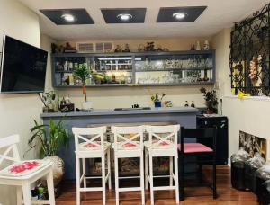 a bar with two white chairs and a counter at Richmond cozy room in Richmond