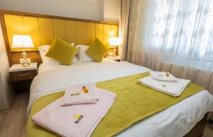 a hotel room with a bed with towels on it at Fera Life Suit Apart in Trabzon