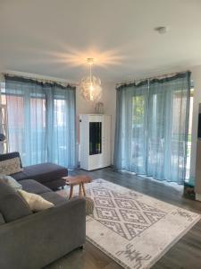 a living room with a couch and a table at Ferienwohnung Südterrasse mit Kamin Bj 2019 in Timmendorfer Strand