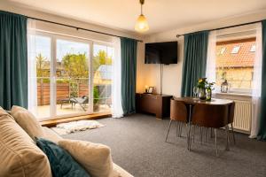 a living room with a couch and a table at Apartamenty na Fali in Mrzeżyno