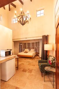 a large room with a bed and a chandelier at Goood Resort in Kralendijk