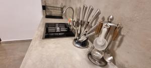 a counter top with utensils and utensils at Moksha Villa-Hostel Kandy in Kandy