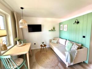 a living room with a couch and a table at Bungalow Green Forest in Benz