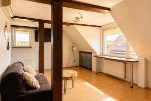 a living room with a couch and a table at Apartamenty na Fali in Mrzeżyno