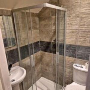 a bathroom with a shower and a toilet and a sink at Alexander's luxury rooms all en-suite, spa bath in Blackpool