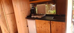 a small kitchen with a stove and a sink at Camping Amable in Someren