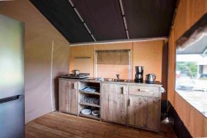 a small kitchen with a sink and a counter at Camping De Kooiplaats in Schiermonnikoog +10 photos
