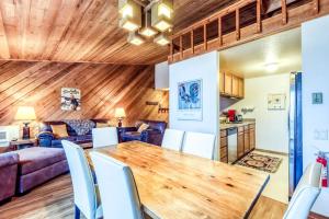 a dining room and living room with a wooden ceiling at Ridge Hideaway in Sun Valley