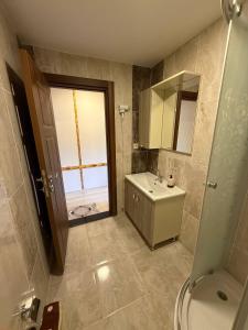 a bathroom with a sink and a toilet and a mirror at Erkonak Pansiyon in Uzungöl +65 photos