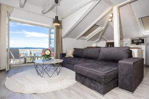 a living room with a couch and a table at Villa Vita luxury Apartments in Crikvenica