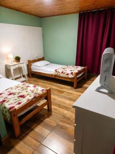 a room with two beds and a purple curtain at Panambí in Colón