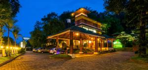 a building on a street at night at Upavan Resort in Vythiri