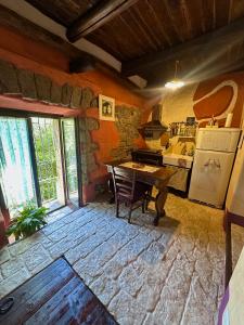 a kitchen with a table and a stove in a room at I tini in Cori