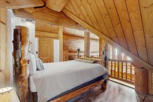 a bedroom with a bed in a room with wooden ceilings at Mogul Hill Cabin in Sandpoint
