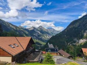 a view of mountains from a cabin in the mountains at Hotel Restaurant Waldrand in Isenfluh
