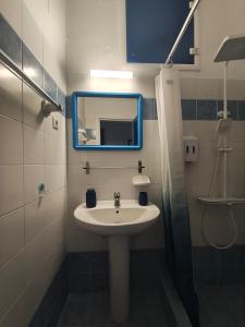 a bathroom with a sink and a mirror at ENDLESS BLUE Milos in Provatas