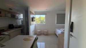 a room with a kitchen and a bedroom with a bed at Studio V Ininga in Teresina +12 photos