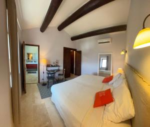 a bedroom with a bed and a table in a room at Les Cachots in Roussillon +12 photos