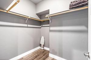 a walk in closet with gray walls and wooden flooring and a sliding door at Eagles Nest in Sagle +62 photos