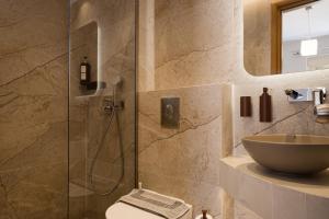 a bathroom with a sink and a glass shower at Plaza Hotel in Zakynthos +91 photos