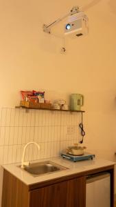 a kitchen counter with a sink and a light at Lấp Ló Home in Danang +18 photos