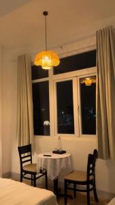 a room with a table and chairs and a window at Lấp Ló Home in Danang