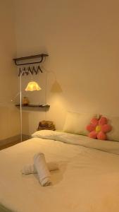 a bedroom with a white bed with a flower on it at Lấp Ló Home in Danang
