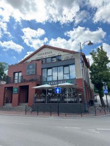 a building on the corner of a street at Sauna Dharma Stay Self check in in Telšiai