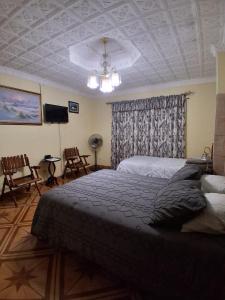 a bedroom with a bed and a coffered ceiling at Alexander b&b in Alajuela