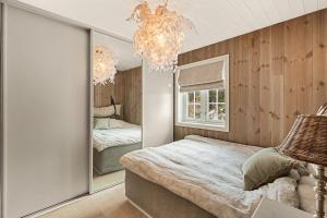 a bedroom with a large mirror and a bed at Cozy and modern cabin in Vossevangen