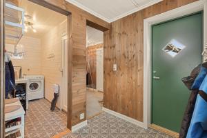 a room with a door leading to a laundry room at Cozy and modern cabin in Vossevangen