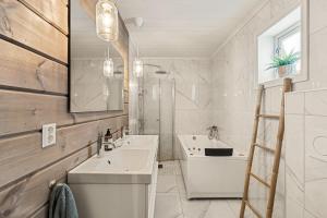 a bathroom with a sink and a toilet and a mirror at Cozy and modern cabin in Vossevangen +27 photos