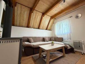 a living room with a couch and a table at Soko Guest House in Žabljak
