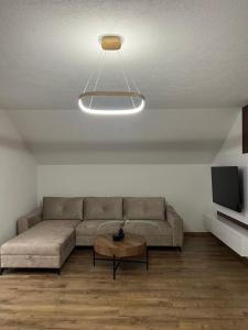 a living room with a couch and a tv at Apartman Rawda in Jajce