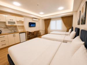 a hotel room with two beds and a kitchen at Stay Istanbul Hotel in Istanbul