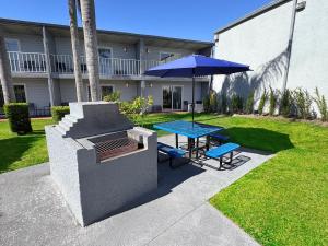 a patio with a table and an umbrella at Celebration Suites in Orlando