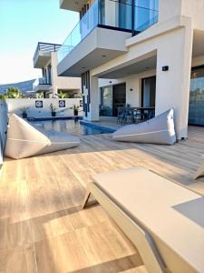 an image of a house with a wooden floor at Aura Mare in Porto Rafti