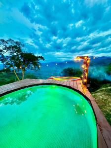 a swimming pool with a view of the mountains at Finca Dulce Amanecer in Villeta