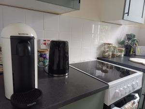 a kitchen with a coffee maker on a counter at Number 47 in Hawick +13 photos