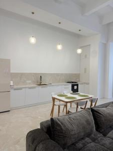 a living room with a couch and a table at Студія біля Прикордонної Академії in Khmelnytskyi